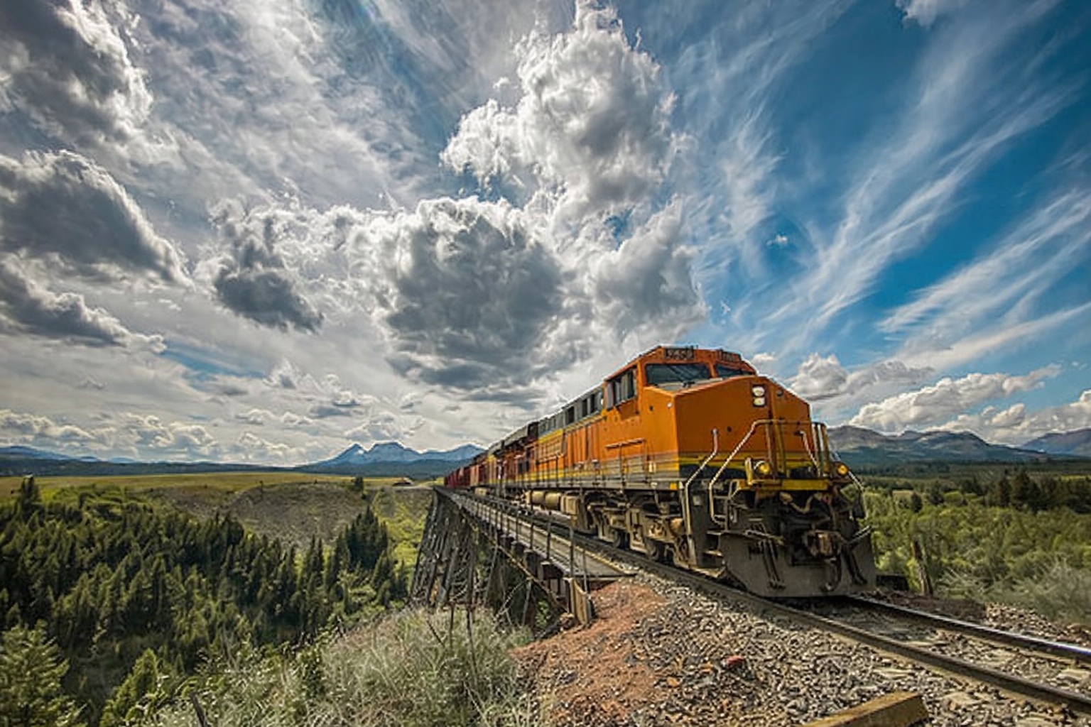 Freight locomotive on trestle bridge — SulNOxEco™ rail fuel additive, 4.5–8% savings